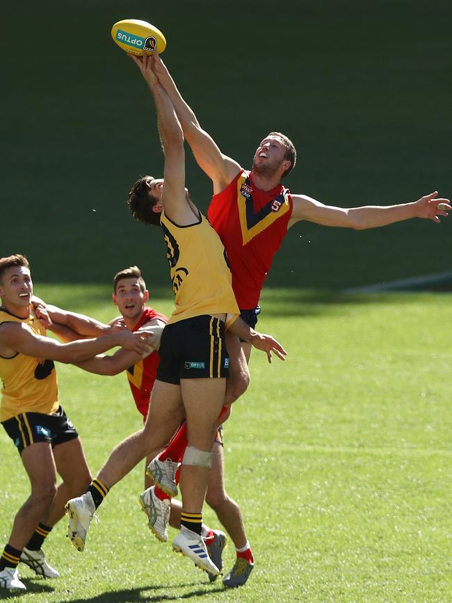 Corey Gault of the WAFL and Michael Knoll of the SANFL contest the ruck during the state game between WA and SA at Optus Stadium. Picture: Paul Kane/Getty Images