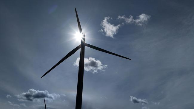 RUNCORN, ENGLAND - SEPTEMBER 21: Wind turbines generate electricity on September 21, 2023 in Runcorn, England. The Prime Minister has announced the postponement of several 