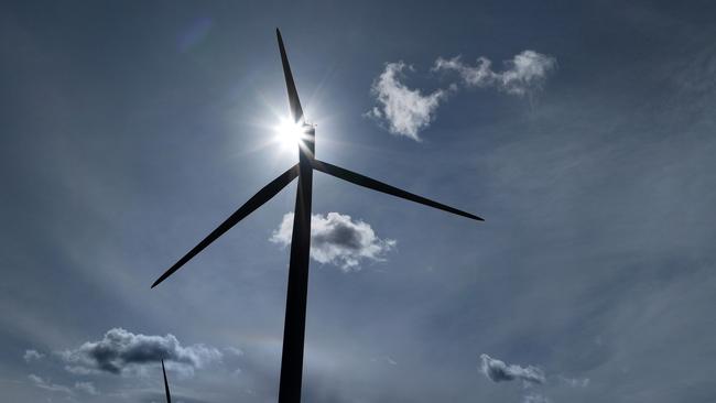 RUNCORN, ENGLAND - SEPTEMBER 21: Wind turbines generate electricity on September 21, 2023 in Runcorn, England. The Prime Minister has announced the postponement of several "green" targets, including a delay of the ban on selling new petrol and diesel cars in the UK. Previously, the ban was to come into effect in 2030, and now will be 2035. (Photo by Christopher Furlong/Getty Images)