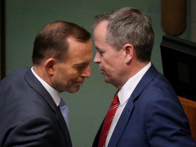 Political adversaries Tony Abbott and Bill Shorten pass each other during a Division in question Time in the House of Representatives, Federal Parliament, Canberra.