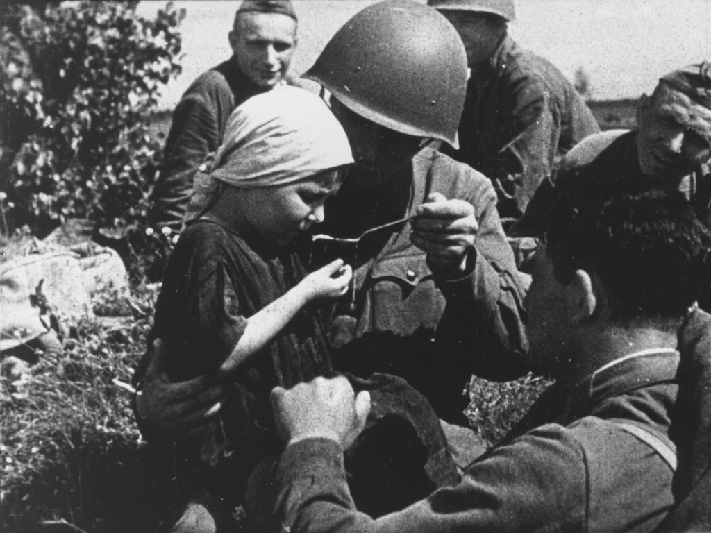 Conditions for thousands of European children during and after World War II were incredibly harsh. This Soviet child is pictured being fed by a Red Army soldier in 1942 at the height of the war. Picture: Picture Post/Hulton Archive/Getty Images