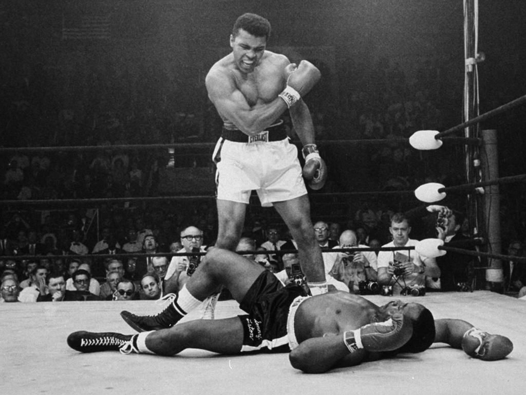 May 25, 1965: Ali stands over fallen champion Sonny Liston during their title bout in Maine.