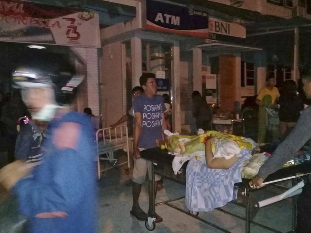 A patient is evacuated from a hospital following a strong earthquake in Poso, central Sulawesi, Indonesia. Picture: AP