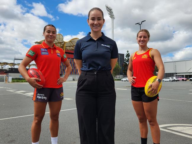 AFL player manager Bella Freeman (middle) with Gold Coast Suns player Lucy Single (left) and Suns academy player Caitlin Miller.