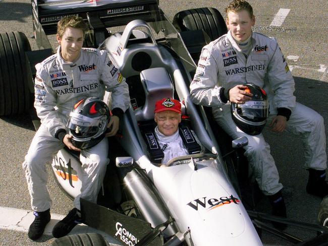 Niki Lauda sitting in McLaren Mercedes alongside his sons, Mathias, left, and Lukas, right.