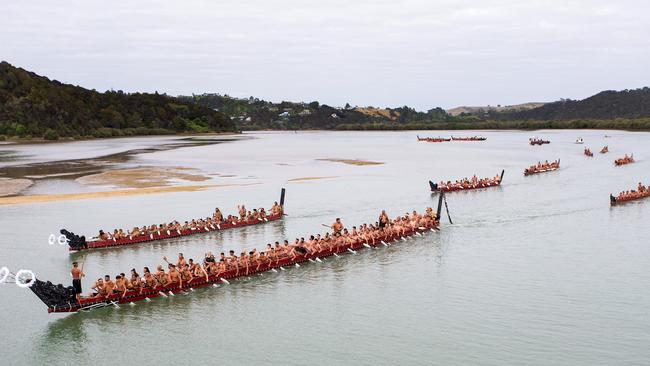 Traditional waka paddle down the Waitangi River on Waitangi Day. Picture: AAP.