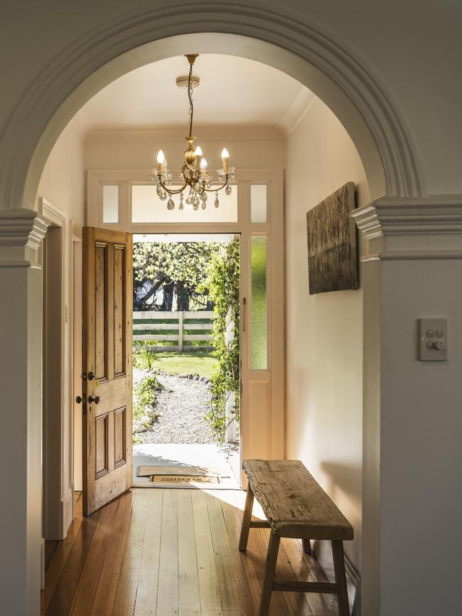 The view down the cottage’s hallway, as the soft glow of the warm afternoon sun filters through the doorway. Picture: Joe Chelkowski