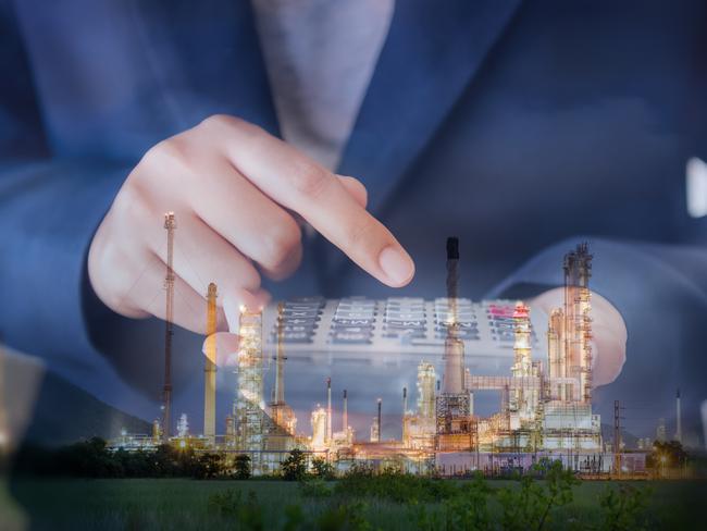 Business Accountant Woman Using Calculator for Calculating Financial Investment Profit Estimate, Double Exposure of Businesswoman is Calculating Tax Expense Against Oil/Gas Refinery Plant Background.