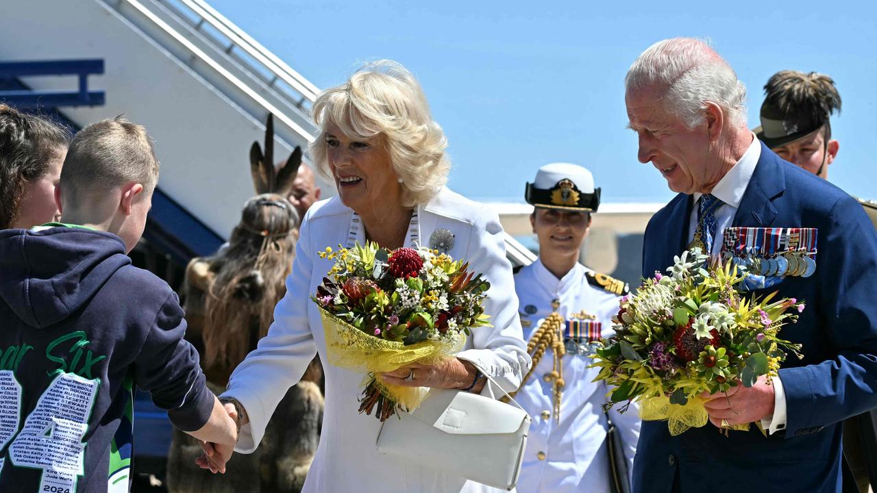 King Charles III and Queen Camilla receive flowers after arriving at Defence Establishment Fairbairn in Canberra on October 21, 2024. Picture: NewsWire / POOL / Saeed Khan