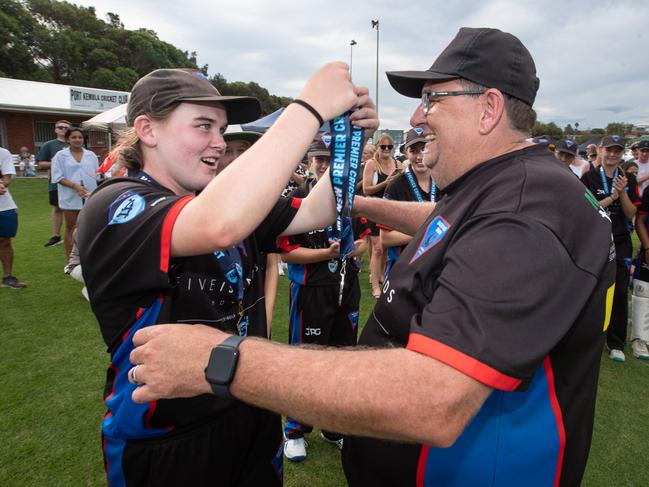 Family values: Player of the match and Swans captain Nicola Hudson hands a premiership medal to co-coach and father, Aaron Hudson. Picture: Julian Andrews