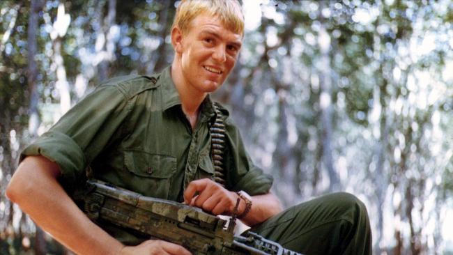 Graham Cornes holding a machine gun during his Vietnam tour of duty in 1970.