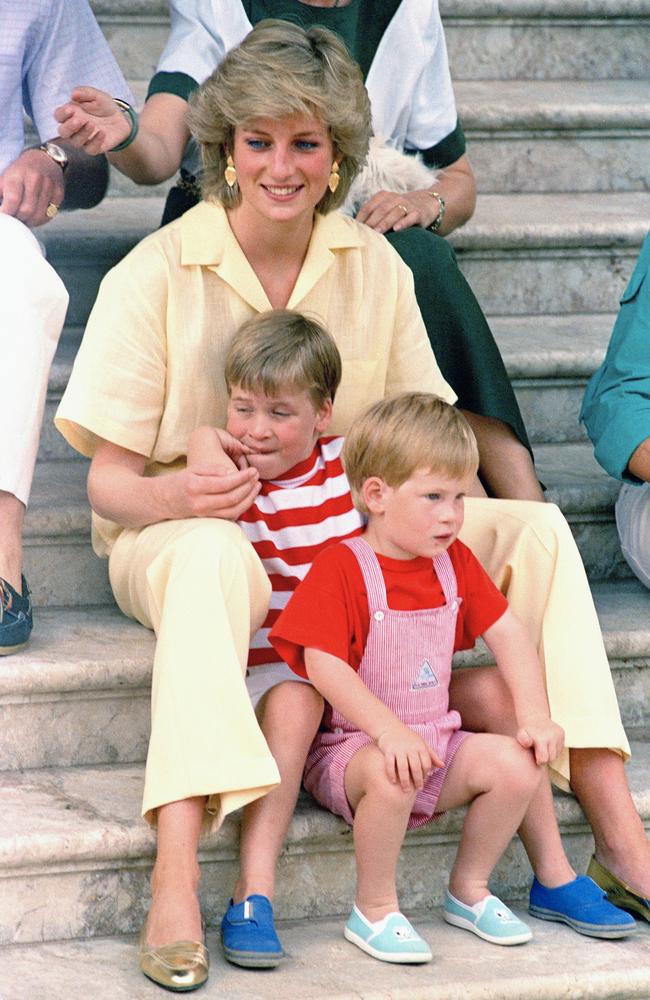 Princess Diana of Wales smiles as she sits with her sons, Prince Harry, front, and William, on the steps of the Royal Palace on the island of Mallorca, Spain. Photo: AP Photo/John Redman