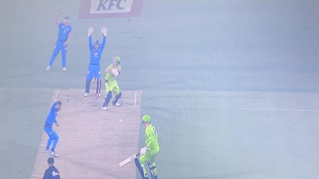 A TV grab of the match being played in smoky conditions in Canberra.