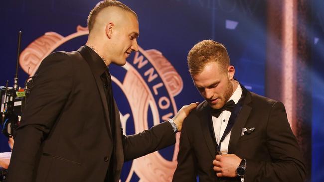 2018 Brownlow Medal winner Tom Mitchell receives the medal from last year’s winner Dustin Martin. Picture: Michael Klein