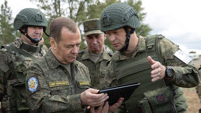 Dmitry Medvedev, left, visits a military training field in Siberia. Picture: AFP