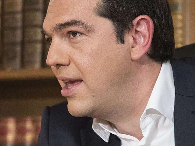 A handout photo made available by the Prime minister's office shows Greece's Prime Minister Alexis Tsipras during his interview for ERT state television on July 14, 2015. Tsipras said he took responsibility for a hardline deal clinched with the eurozone to save the near-insolvent country, despite not believing in many of the draconian reforms it demands. "I assume responsibility for all mistakes I may have made, I assume responsibility for a text I do not believe in, but which I signed to avoid disaster for the country, the collapse of the banks," he said in an interview on Greece's public television on the eve of a key parliament vote on the reforms. AFP PHOTO/HO/PRIME MINISTER OFFICE/ANDREA BONETTI ==RESTRICTED TO EDITORIAL USE - MANDATORY CREDIT "AFP PHOTO /HO/PRIME MINISTER OFFICE/ANDREA BONETTI " - NO MARKETING NO ADVERTISING CAMPAIGNS - DISTRIBUTED AS A SERVICE TO CLIENT - AFP IS NOT RESPONSIBLE FOR ANY DIGITAL ALTERATIONS TO THE PICTURE'S EDITORIAL CONTENT, DATE AND LOCATION ==