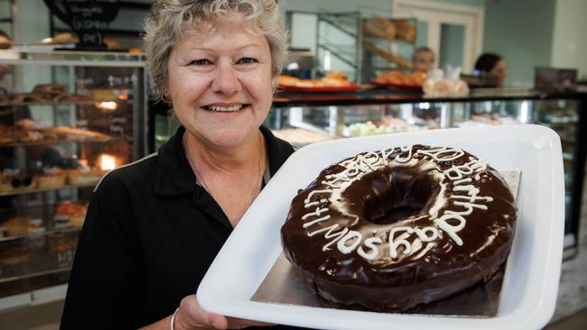 Litl Mo's Bakery owner Deb Moten with one of their favourite dinnerplate-sized donuts. Picture: Kelly Barnes