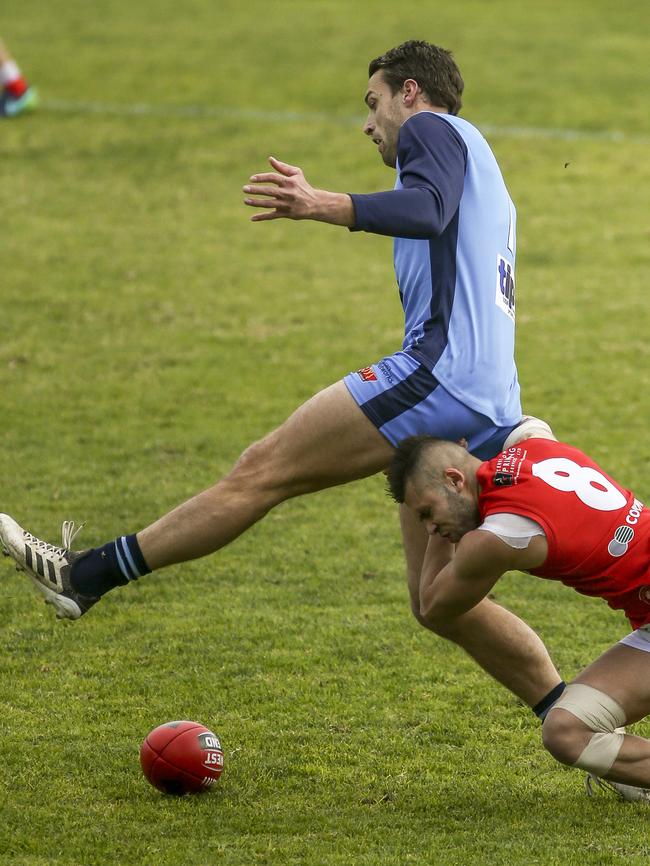 North Adelaide’s Robbie Young catches Sturt player Fraser Evans. Picture: AAP/MIKE BURTON