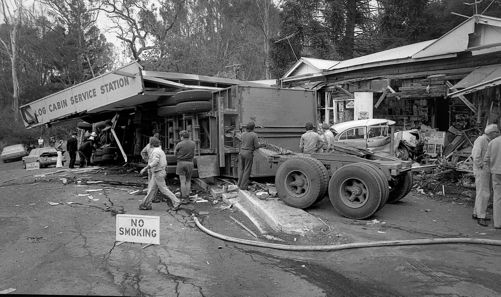 Historic: Toowooba: Accidents Semi-trailer crash at the Log Cabin Service Station on the Toowoomba Range in on 6th September,1978. Three men suffered minor injuries during the crash when the semi-trailer rolled taking out petrol bowsers. A car parked at the service station was also damaged. Photo: Bruce Mackenzie / The Chronicle Neg U869. Picture: Bruce Mackenzie