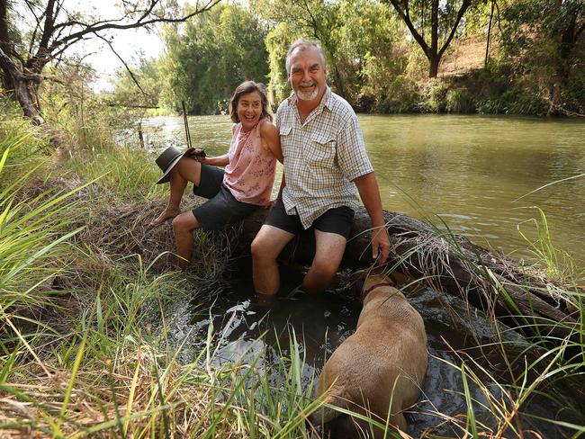 John and Gail Craigie relax on the banks of the Brisbane river, 25 metres below their house which flooded in 2011, at Pine Mountain, west of Brisbane. John organised the successful class action against the state. Picture: Lyndon Mechielsen/The Australian