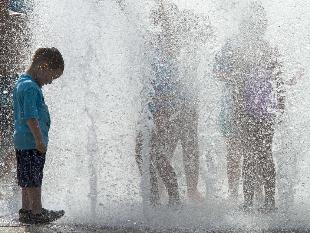 Children cool down from the heat wave gripping the US east coast at the outdoor interactive water fountain on June 16, 2015 at the Fairfax Square shopping mall courtyard in Fairfax, Virginia. Picture: AFP