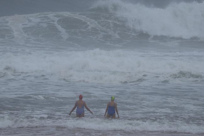 People braving the big surf on the northern beaches. Picture: John Grainger