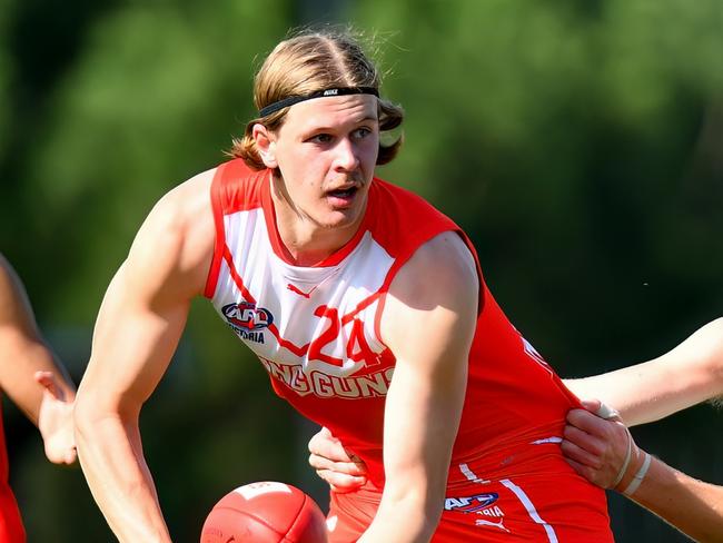 MELBOURNE, AUSTRALIA - APRIL 28: Joe Pike of the Young Guns handballs whilst being tackled during the 2024 Young Guns Series match between the Young Guns and the Victoria Country U18 Boys at Highgate Recreation Centre on April 28, 2024 in Melbourne, Australia. (Photo by Josh Chadwick/AFL Photos)