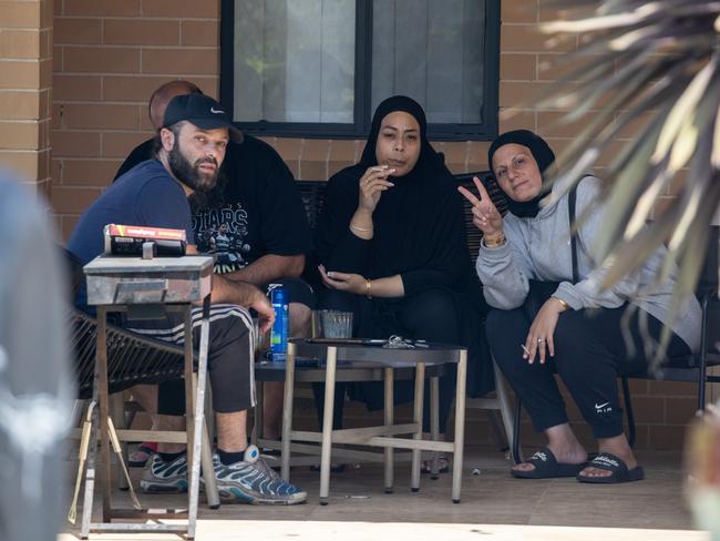 Associates of Sarah Abu Lebdeh outside her Condell Park home on Wednesday afternoon.