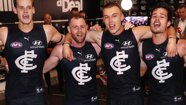 Cripps and Docherty sing the team song in a memorable night for the club. Picture: Michael Klein