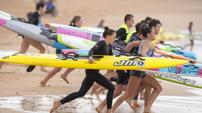 Maroubra ironwoman Lizzie Welborn (middle) during a training session at Newport surf life saving club.