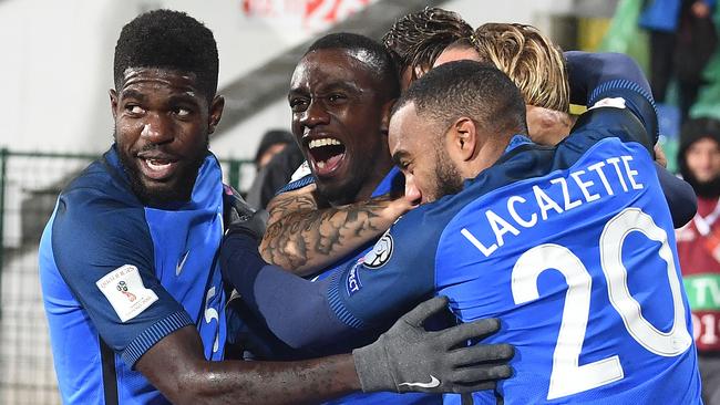 France's midfielder Blaise Matuidi (C) celebrates with teammates after scoring his team's first goal.