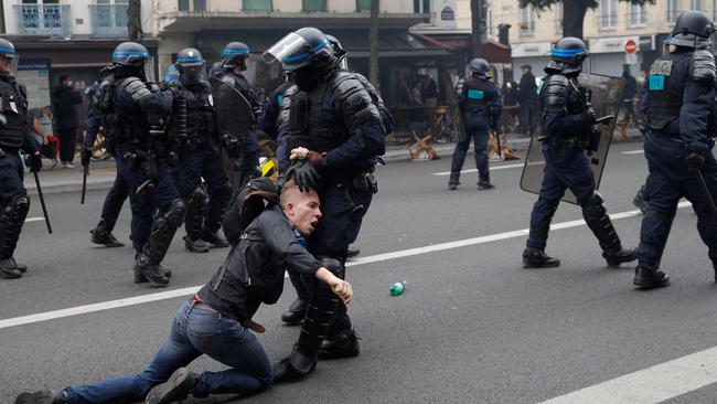 A policeman detains a man in a demonstration on the streets of Paris. Picture: AFP