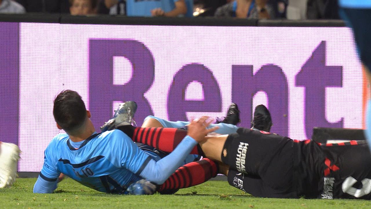 Daniel Georgievski (R) earned a red card after he kicked out at Sydney's Marco Tilio.