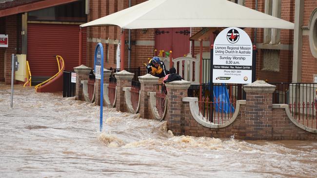 Swiftwater rescue crews rescue a man from the Uniting Church steps in Keens Street, Lismore.