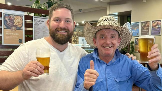 Walloon Hotel owner Stewart Gibson toasts with local legend Scotty who returned a number of glasses to the hotel. Picture: Walloon Hotel