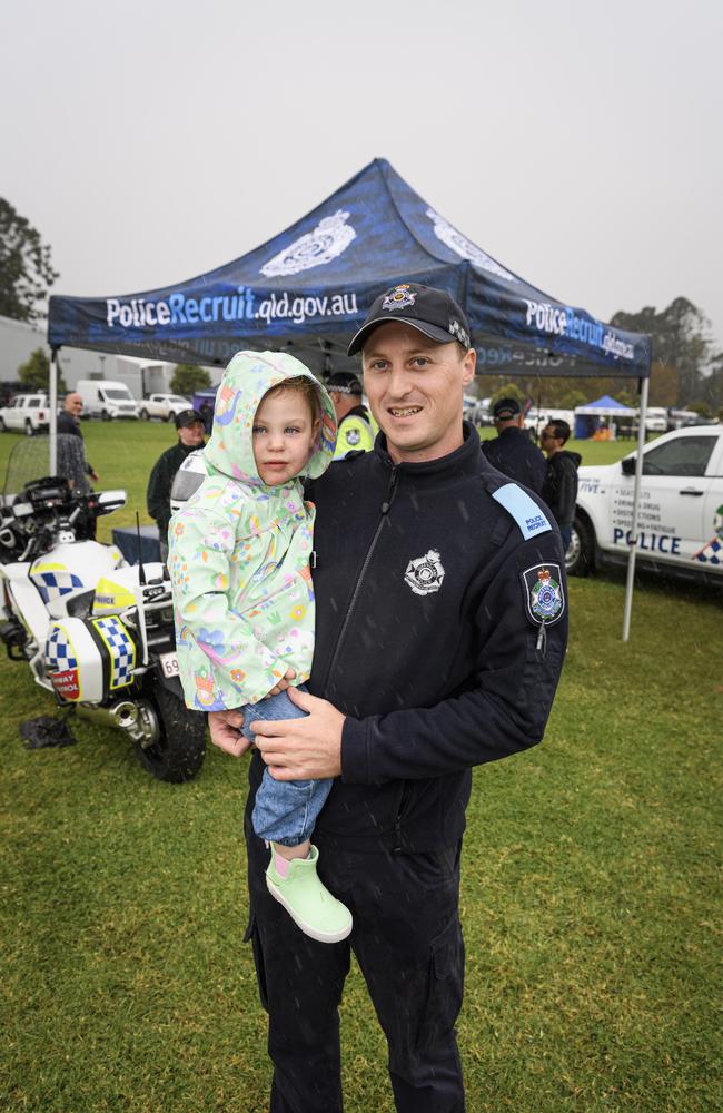 Police recruit Matthew Blackwell with daughter Isla Blackwell at the Queensland Police Community Safety and Career Expo on the TAFE oval, Saturday, May 31, 2025. Picture: Kevin Farmer