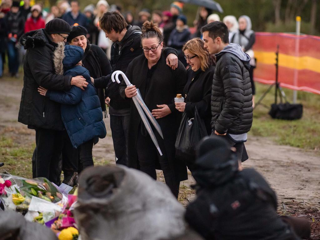 Courtney Herron’s family members in tears as they view the flowers and tributes left at her makeshift shrine. Picture: Jason Edwards