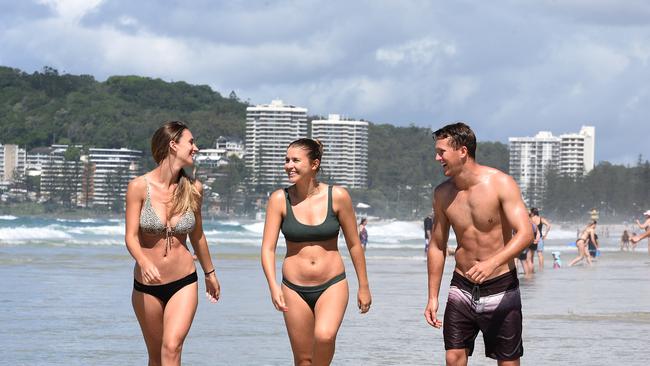 Lauren Younger, 27, Ellie Smith, 24, and Jake Ryan, 24, all from the NSW south coast visit North Burleigh Heads. Picture: AAP/John Gass