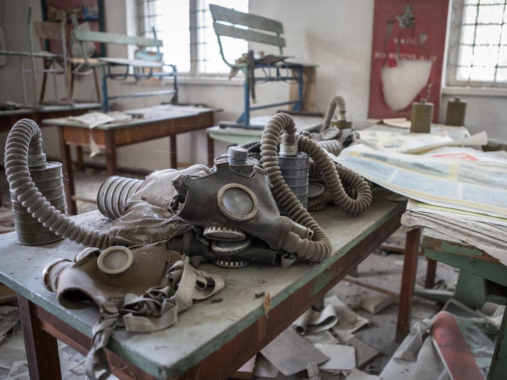 Old gasmasks left sitting on a school desk in an abandoned classroom. Picture: Erwin Zwaan