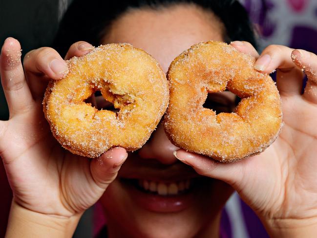 Fiona Sang prepares one of the last batches of cinnamon donuts which will be on sale 2 for 1 as the store prepares to close its doors at Casuarina Square.