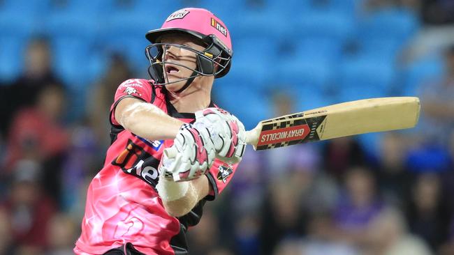 Sam Billings launches one of two sixes in the final over that almost carried the Sydney Sixers to their first win of the BBL 07 season against the Hurricanes. Photo: Rob Blakers