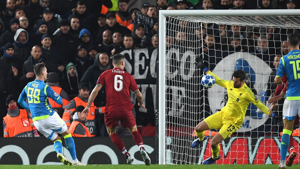 Liverpool's Brazilian goalkeeper Alisson Becker (2R) saves a shot from Napoli's Polish striker Arkadiusz Milik (L)