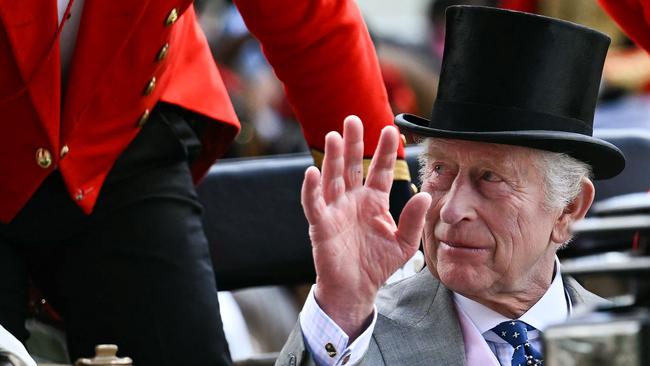 Britain's King Charles III waves as he arrives by carriage during the Royal Procession to attend the fourth day of the Royal Ascot horse racing meeting, in Ascot, west of London, on June 21, 2024. (Photo by Ben Stansall / AFP)