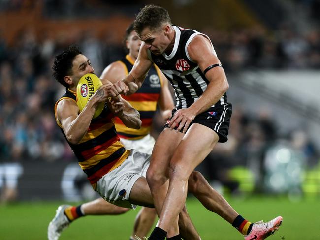 ADELAIDE, AUSTRALIA - AUGUST 17:   Izak Rankine of the Crows is knocked out by  a late hit from  Dan Houston of the Power during the round 23 AFL match between Port Adelaide Power and Adelaide Crows at Adelaide Oval, on August 17, 2024, in Adelaide, Australia. (Photo by Mark Brake/Getty Images)