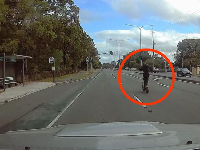 An electric scooter seen overtaking cars at high speed in Runaway Bay on the Gold Coast. Picture: Dave Wyatt.