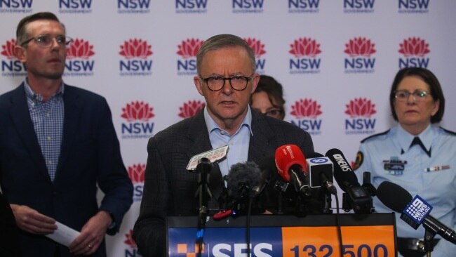 Prime Minister Anthony Albanese (centre) announces flood recovery payments alongside NSW Premier Dominic Perrottet and state emergency officials. Picture: NCA Newswire/ Gaye Gerard