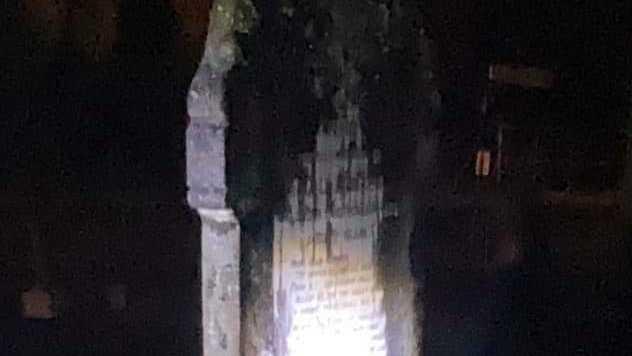 Torch lights gave an eerie glow on the Headstones