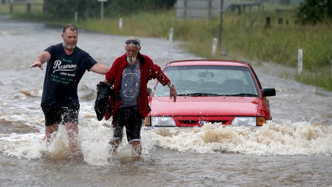 The driver was rescued by locals as it is inundated with flood water. Picture: Nathan Edwards