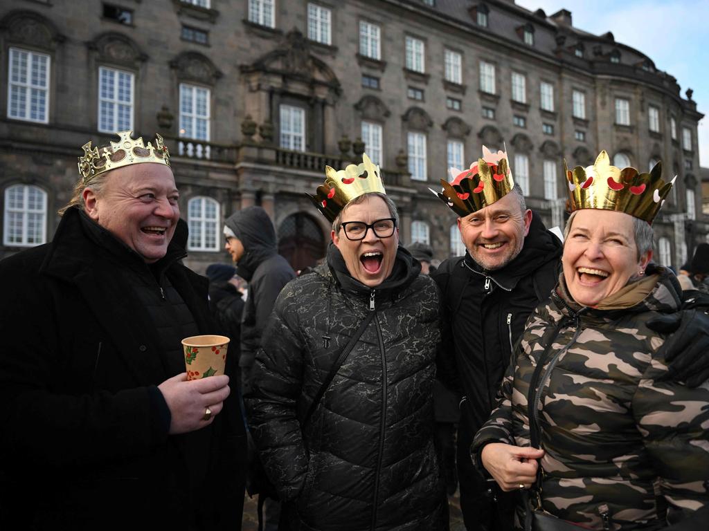 People wearing makeshift crowns celebrating the proclamation of abdication in Copenhagen. Picture: Jonathan Nackstrand/AFP