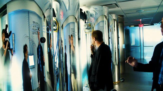 Johnny Boston and a film crew examine a cryonics facility in the film 2030.